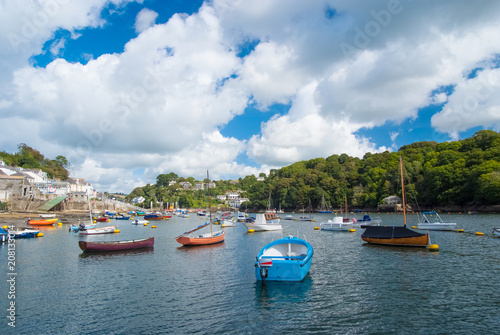 Fowey, United Kingdom - March 24, 2010: boats in sea harbor on cloudy sky. Speed and sailing boats on water. Summer vacation in sea. Travelling by water. Wanderlust and adventure