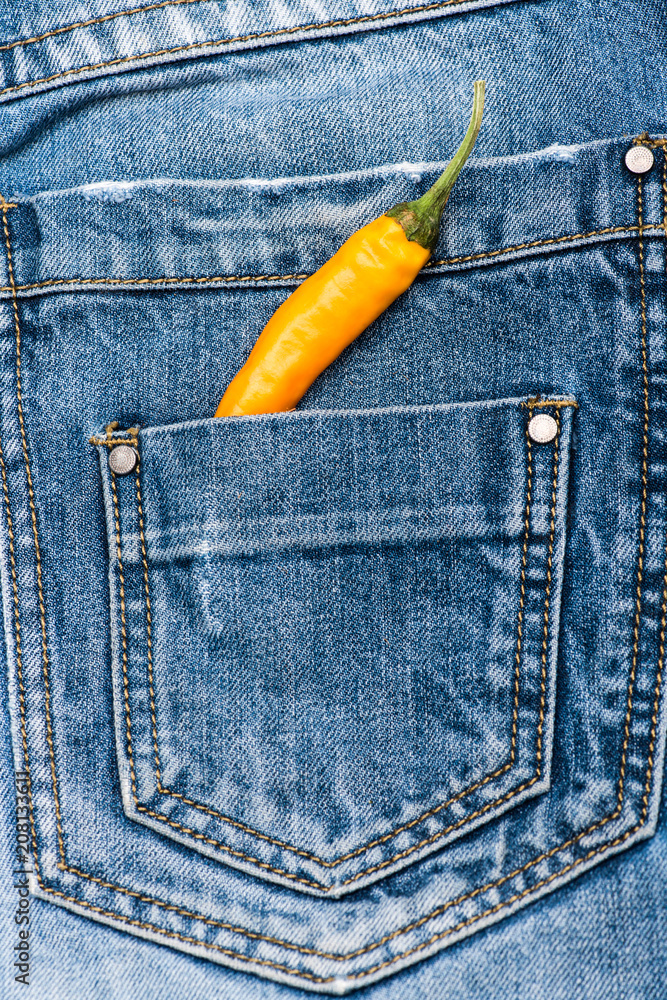 Hot sensations concept. Pepper in back pocket of blue jeans. Pocket of jeans  staffed with yellow chilly pepper, denim background. Piquant secret in  pocket of pants, top view Stock Photo | Adobe