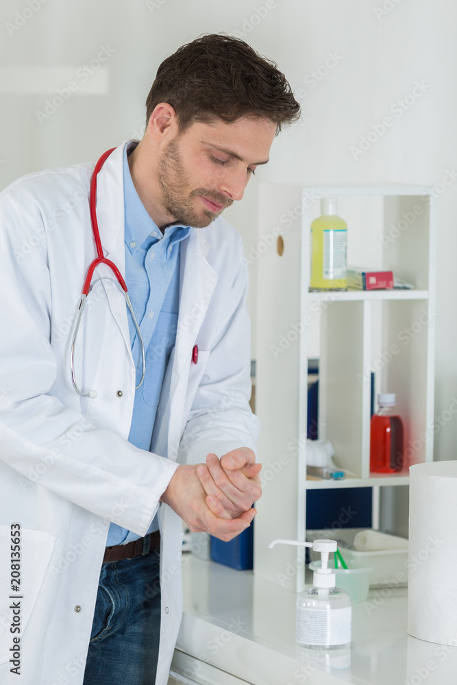 medical doctor using sanitizer dispenser medical doctor using sanitizer dispenser