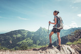 Healthy fit young woman hiker on a mountain summit