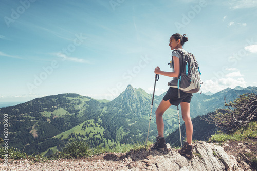 Healthy fit young woman hiker on a mountain summit photo