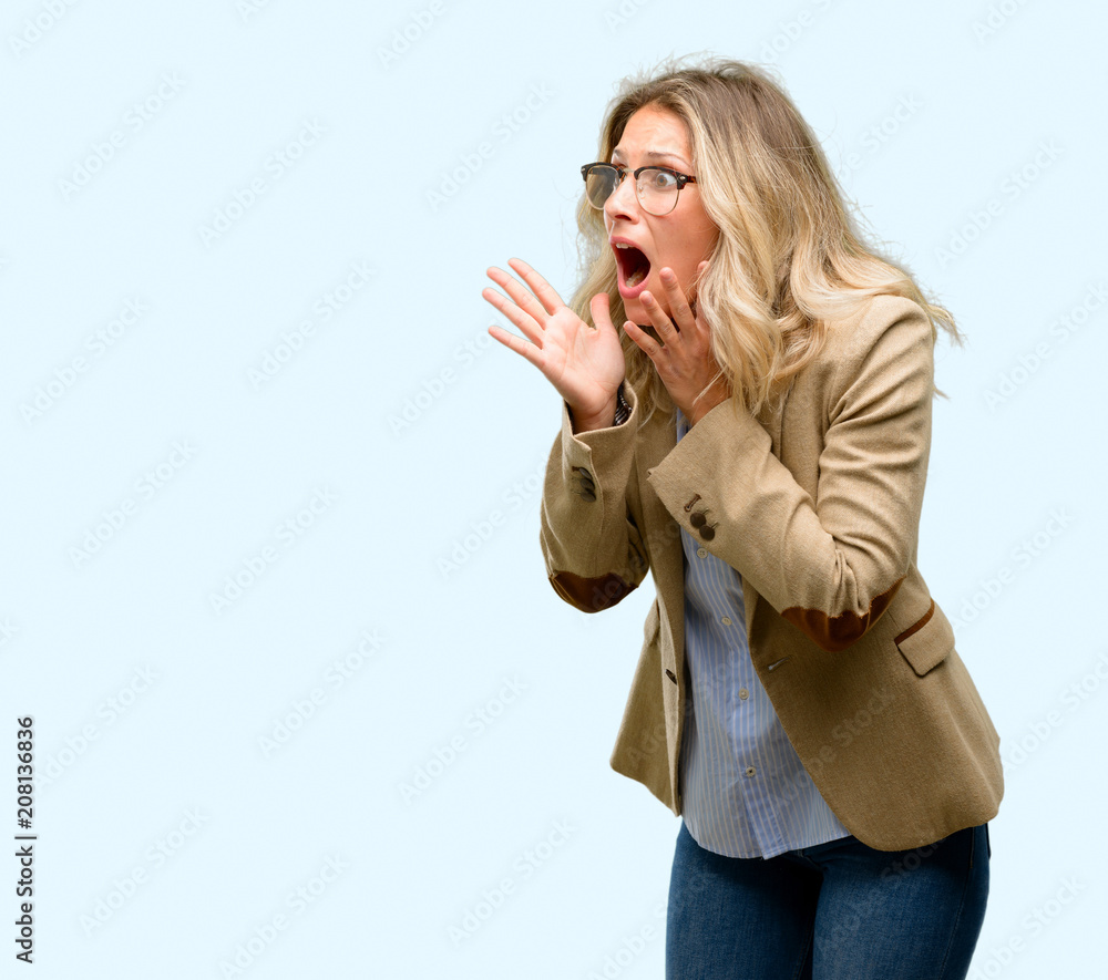 Young beautiful woman stressful keeping hands on head, terrified in panic, shouting Young beautiful woman stressful keeping hands on head, terrified in panic, shouting