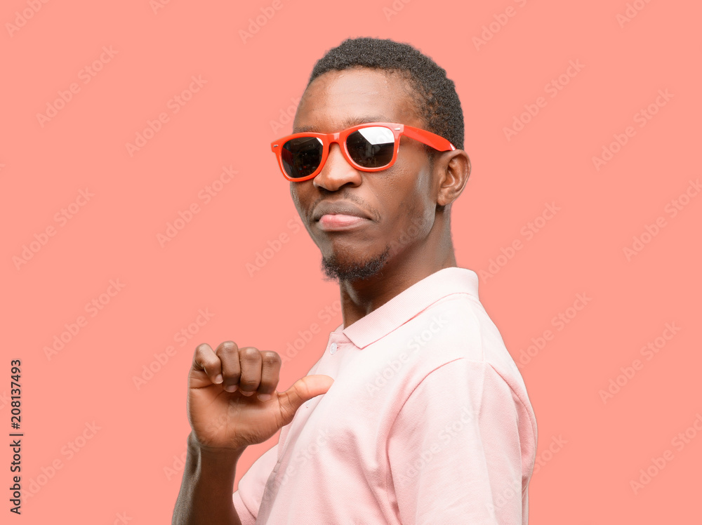 African black man wearing sunglasses proud excited and arrogant pointing with victory face Stock Photo Adobe Stock