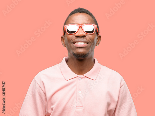African black man wearing sunglasses thinking and looking up expressing doubt and wonder