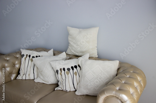 Cream leather sofa. Interior with furniture. Linen pillows on the leather sofa. photo