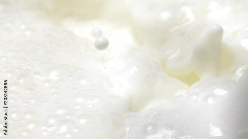Close-up milky liquid boil up in slow motion Close-up milky liquid boil up in slow motion