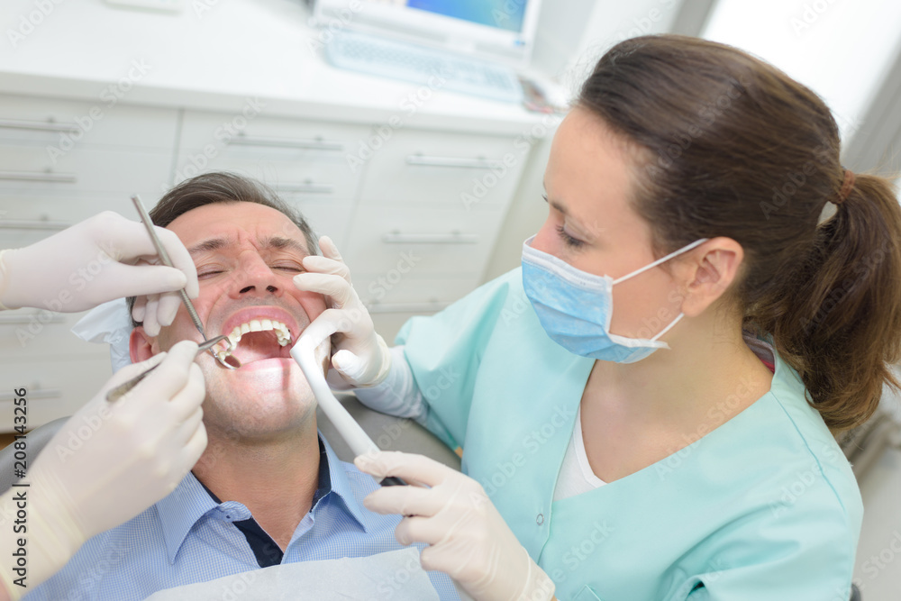 female dentist with man patient at dental clinic office female dentist with man patient at dental clinic office