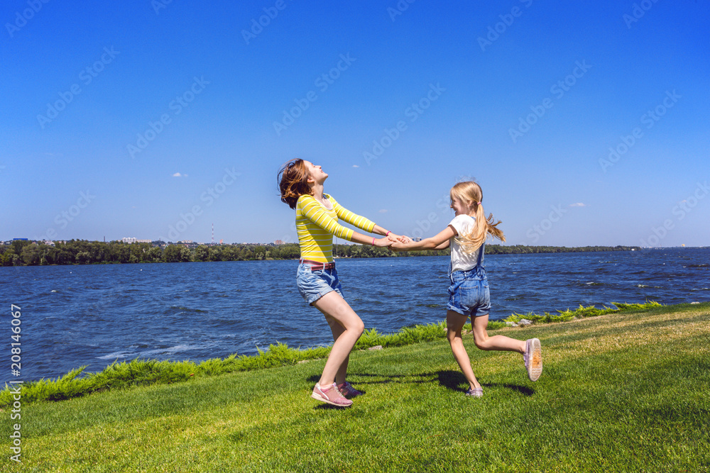 Beautiful sisters girl on the meadow Beautiful sisters girl on the meadow