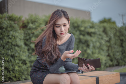 Asian woman with empty wallet .
