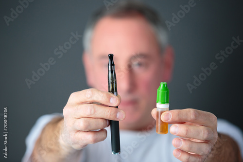 Wallpaper Mural close-up of an electronic cigarette in mans hands Torontodigital.ca