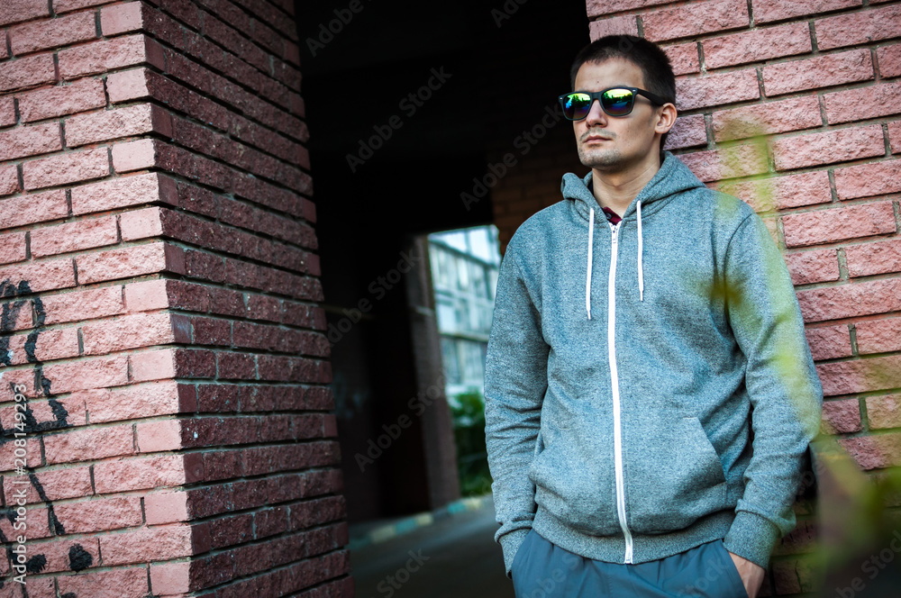 Portrait of a young man with glasses on the street Portrait of a young man with glasses on the street