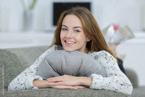 portrait of beautiful girl laying on sofa smiling