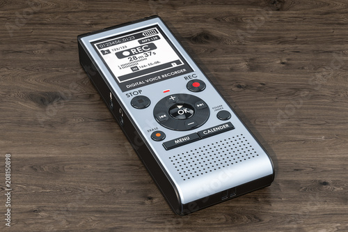Digital voice recorder, dictaphone on the wooden table. 3D rendering photo