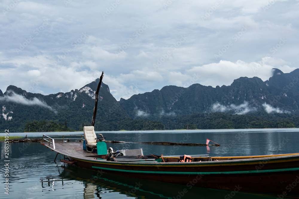 Wooden long-tail boat on docked on a lake in Khao Sok, Thailand