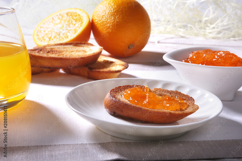 Morning Breakfast set with orange jam on bread toast and juice in glass. Morning Breakfast set with orange jam on bread toast and juice in glass.