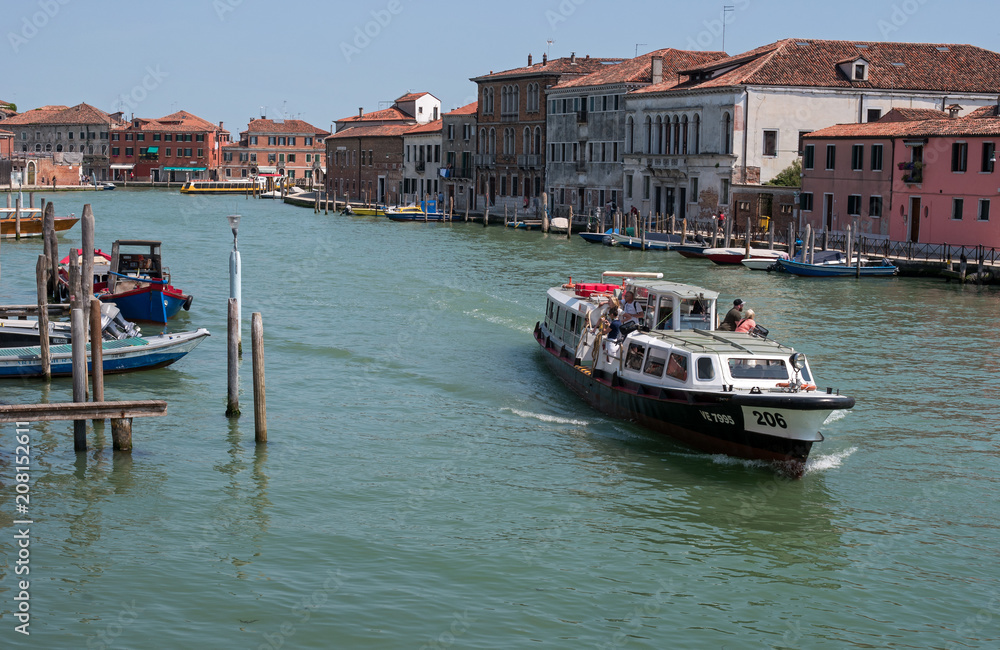 Obraz premium Island Murano in Venice Italy. View on canal with boat and motorboat water. Picturesque landscape. Traditional view of The Venetian canals