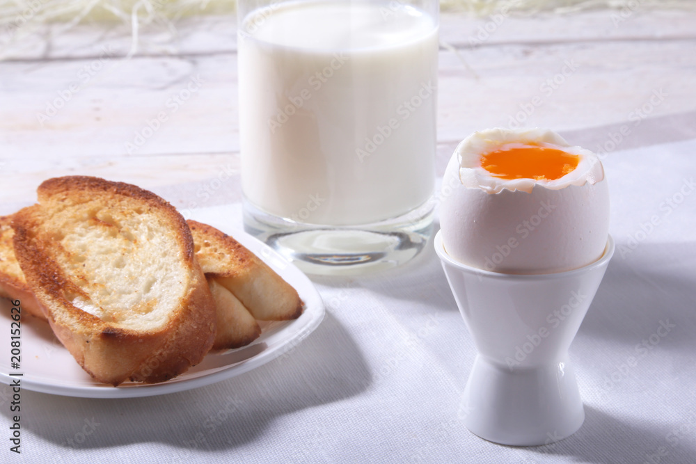 Morning Breakfast set with egg, orange jam on bread toast and milk in glass. Morning Breakfast set with egg, orange jam on bread toast and milk in glass.