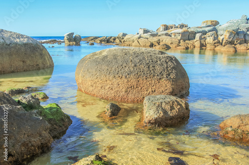 The beautiful and hidden Oudekraal Beach with its calm, turquoise waters, white sand and large boulders, part of Table Mountain area in Cape Town. This area is popular for diving because marine life. photo