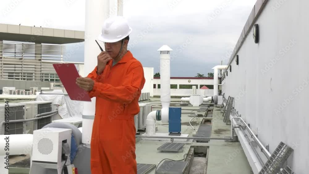 Asian engineer wear safety helmet working on the terrace of the building,Maintenance of air conditioning system in the building,Thailand people Asian engineer wear safety helmet working on the terrace of the building,Maintenance of air conditioning system in the building,Thailand people