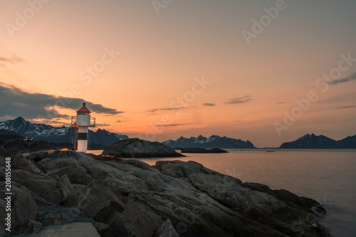 The lighthouse at the fishing harbor of Kabelvag at Lofoten Islands / Norway at sunset