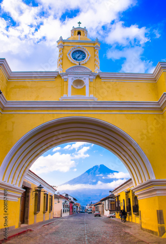 ANTIGUA, GUATEMALA - MARCH 25 2013: The famous arch of the city center of Antigua together with tourists and vendors of arts and crafts. photo