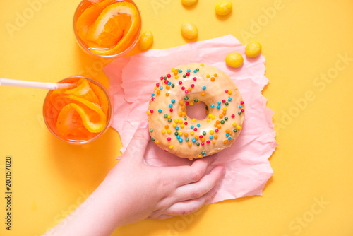 Donut on yellow background. Top view. Copy space. photo