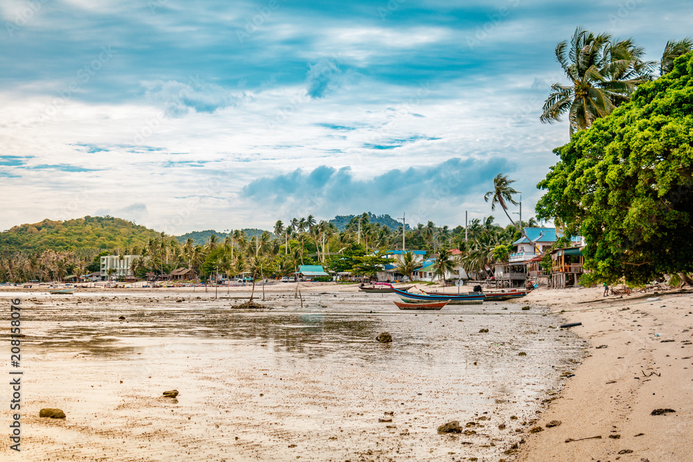 Small fisherman village on a sandy shore during a bright sunny day in Koh Samui, Surat Thani, Thailand Small fisherman village on a sandy shore during a bright sunny day in Koh Samui, Surat Thani, Thailand