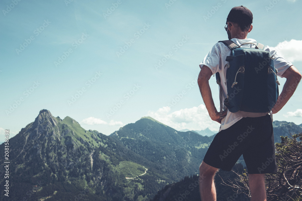 Hiker or backpacker overlooking alpine peaks Hiker or backpacker overlooking alpine peaks