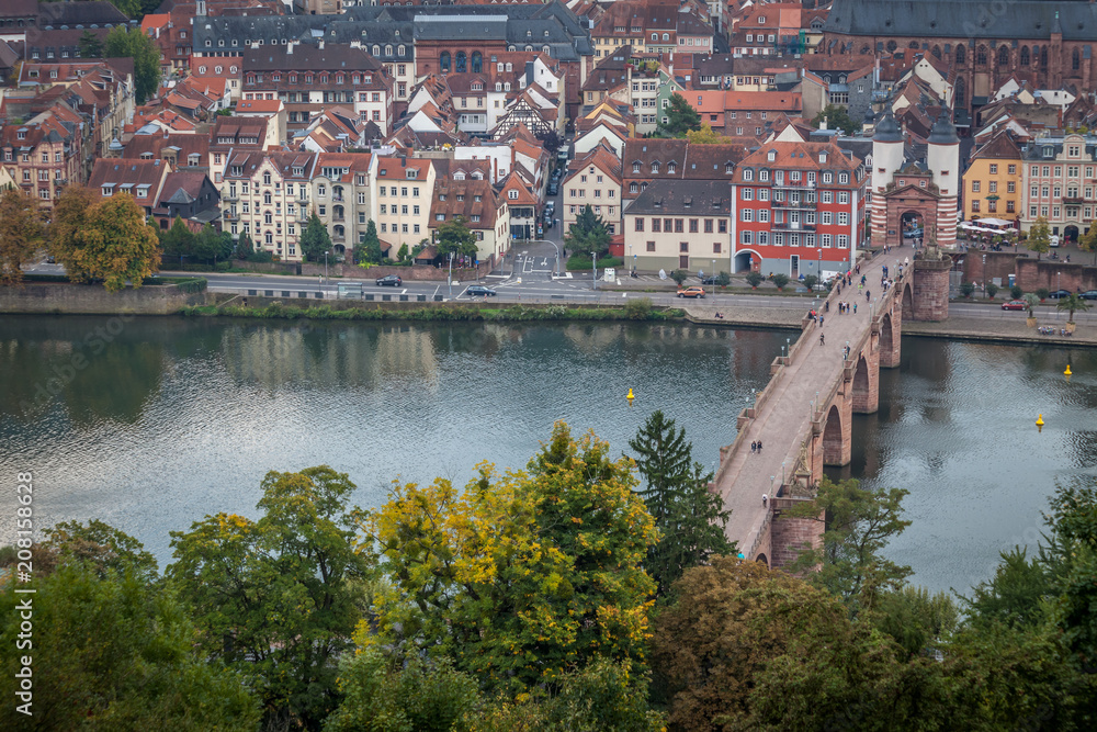 Old Bridge and Old town in Heidelberg with tourists and river Necker