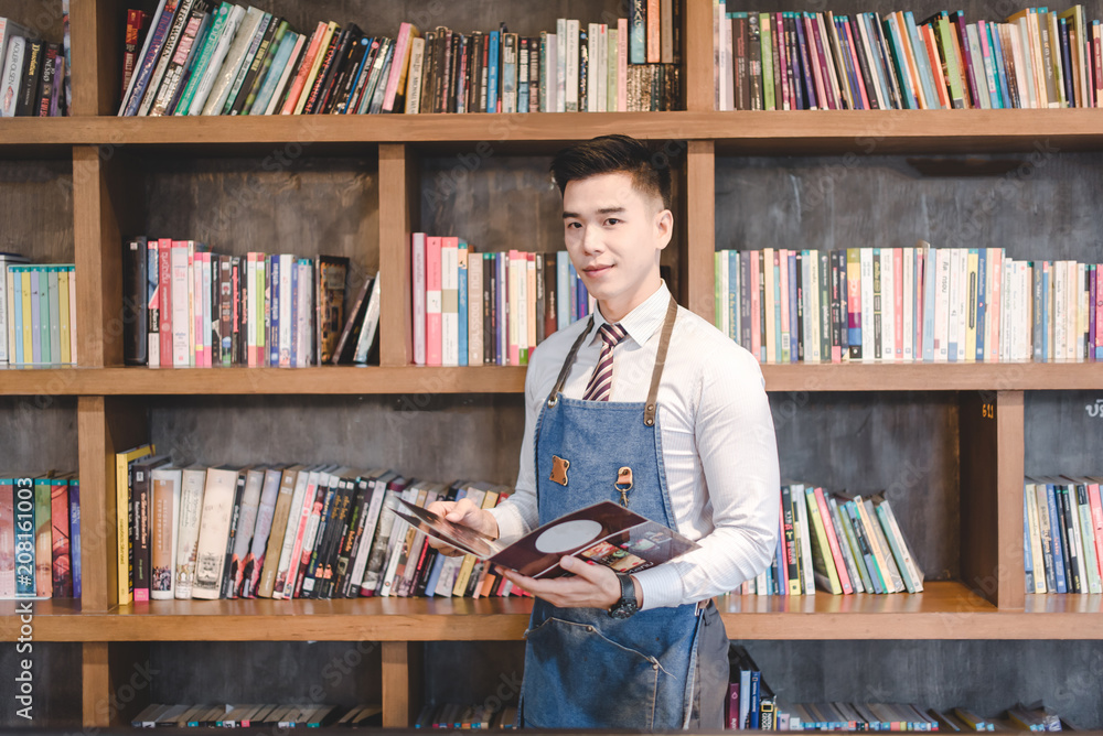 The portrait of the guy baristas at workplace on background of coffee The portrait of the guy baristas at workplace on background of coffee