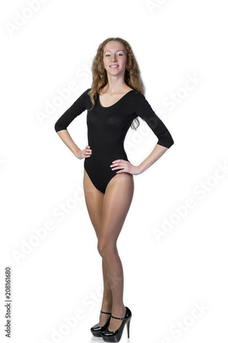 Young slim blonde in black bodys against a white background. Vertical photo. © finist_4