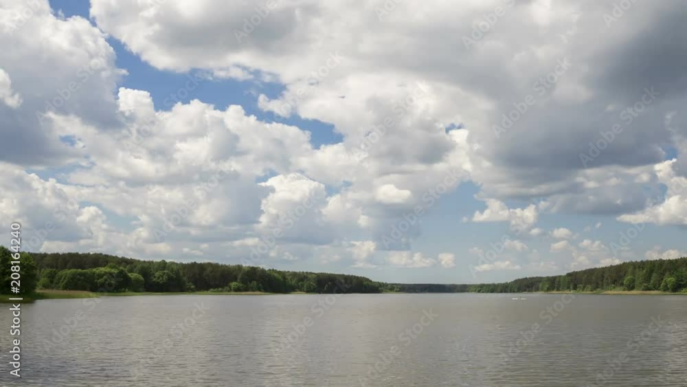 Cumulus cloud over the lake, time-lapse 4K. The movement of clouds over a summer lake.
Cumulus cloud over the lake, time-lapse 4K. The movement of clouds over a summer lake.
