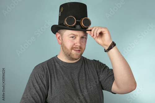 Smiling man in a top hat looking ahead