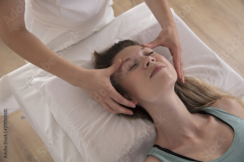 Woman enjoying head massage. Acupressure treatment. Relaxation and Alternative medicine conept