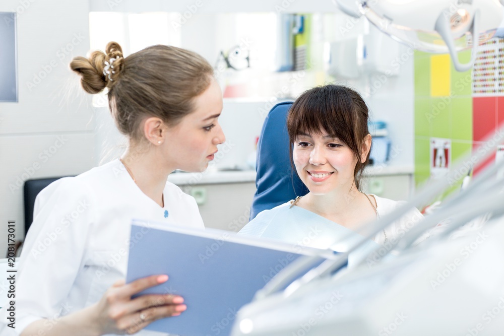 Woman dentist advises the patient in the dental clinic Woman dentist advises the patient in the dental clinic