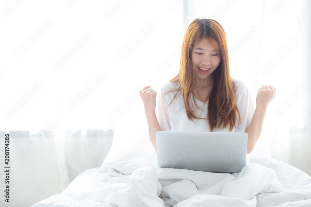 Beautiful happiness young asian woman using laptop work with success on bed in the home, girl and notebook shopping online with glad, communication concept. Beautiful happiness young asian woman using laptop work with success on bed in the home, girl and notebook shopping online with glad, communication concept.