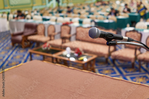 Close up microphone have participant in conference room as background