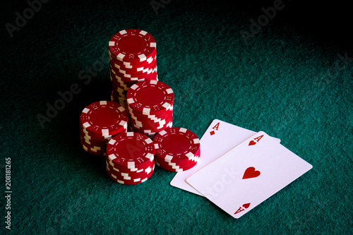 red casino chips and pair of poker aces