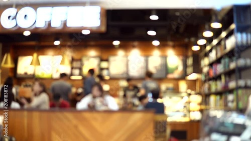 Blurred footage of coffee shop with people drinking coffee. 4K video with defocused effect.