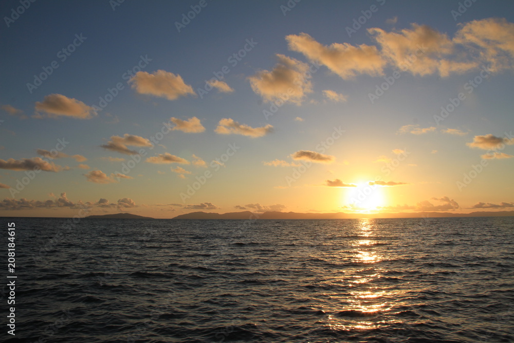 Sunrise over water blue skies and clouds Sunrise over water blue skies and clouds