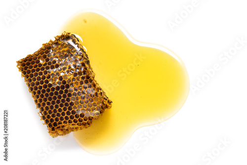 Piece of behive or honeycomb with honey isolated on white background photo