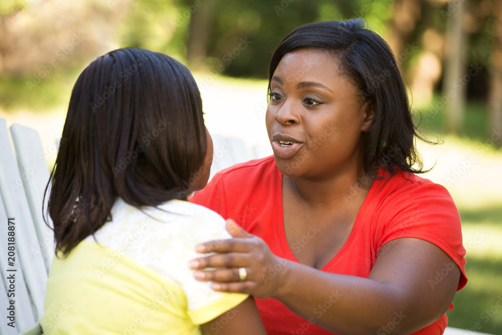 African American mother hugghing her daughter. African American mother hugghing her daughter.