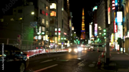ROPPONGI,  TOKYO,  JAPAN - CIRCA JUNE 2018 : TAXI and CAR passing at night time in busy street around Roppongi crossing area.  In blurred.