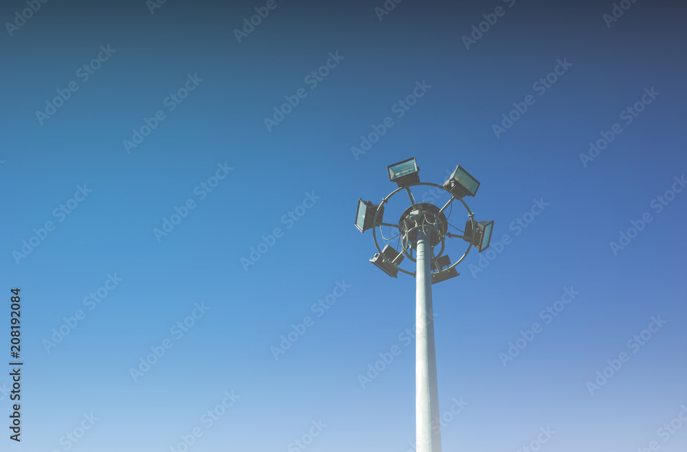 Round steel pole installed spotlights, steel pole with blue sky background.