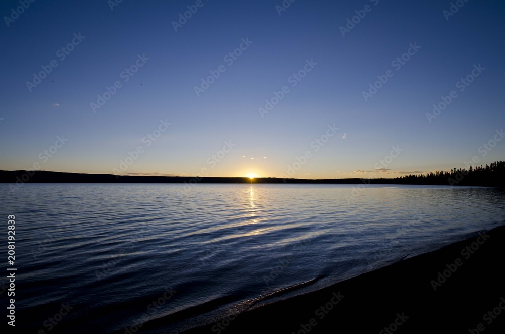 The long sunset across the yellowstone lake in the evening night. 