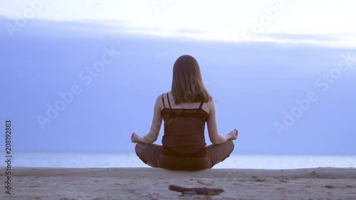 girl meditating by the sea photo