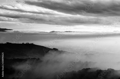 Umbria valley in autumn filled by mist, with emerging hills and 