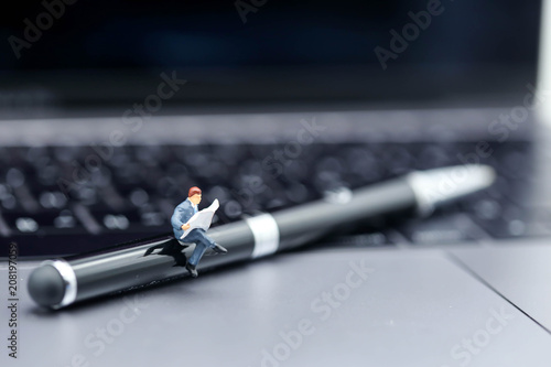 Wallpaper Mural Miniature people : reading a book sitting on pen with laptop,education relax concept. Torontodigital.ca