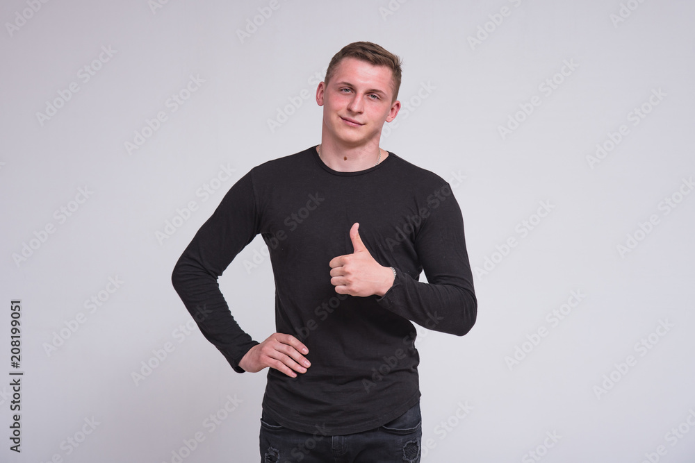Portrait of a cute young guy showing ok on white background. Portrait of a cute young guy showing ok on white background.