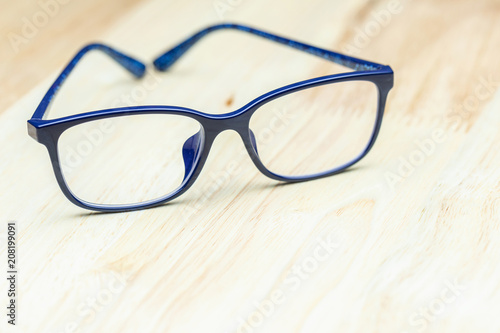 Blue eye glasses on wood table for business  education concept design.